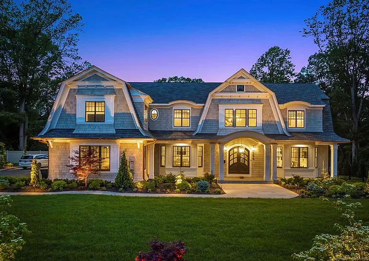 396 Knollwood Rd in Ridgewood is a gray house with gray roof and nicely dormered front elevation
